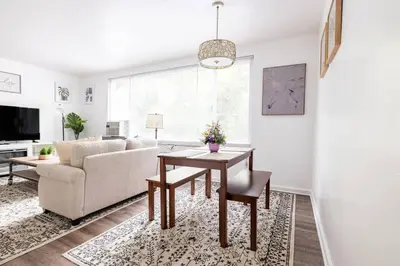 a living room with a table and a couch at Two Bedrooms near CLE airport 2-4b Georgetown Villas in Fairview Park