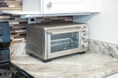 a toaster oven sitting on a counter in a kitchen at Two Bedrooms near CLE airport 2-4b Georgetown Villas in Fairview Park