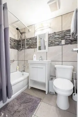 a bathroom with a toilet and a tub and a sink at Two Bedrooms near CLE airport 2-4b Georgetown Villas in Fairview Park