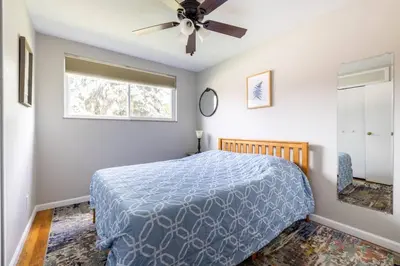 a bedroom with a bed and a ceiling fan at Courtyard View near Valley 2-2a Georgetown Villas in Fairview Park
