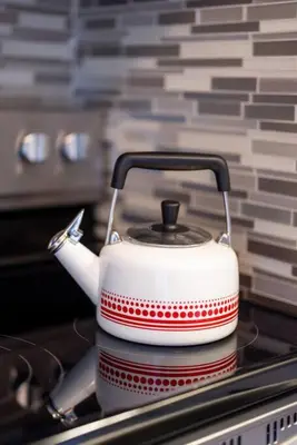 a tea kettle sitting on top of a stove at Courtyard View near Valley 2-2a Georgetown Villas in Fairview Park