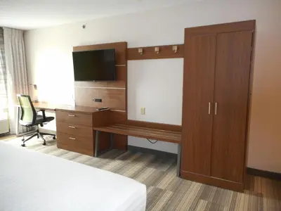 a hotel room with a desk and a television at Holiday Inn Express Fairfield by IHG in Fairfield