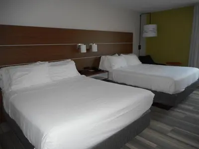 two beds in a hotel room with white sheets at Holiday Inn Express Fairfield by IHG in Fairfield