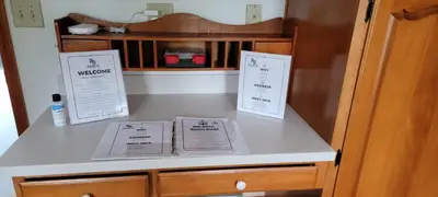 a counter with two signs on top of a cabinet at 100 Acre Red Brick Ranch Hocking Hills Cabin Hot Tub 12 in Logan
