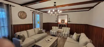 a living room with a couch and a table at 100 Acre Red Brick Ranch Hocking Hills Cabin Hot Tub 12 in Logan