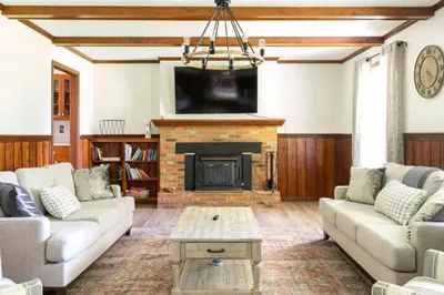 a living room with a couch and a fireplace at 100 Acre Red Brick Ranch Hocking Hills Cabin Hot Tub 12 in Logan