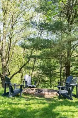 three chairs and a fire pit in the grass at 100 Acre Red Brick Ranch Hocking Hills Cabin Hot Tub 12 in Logan