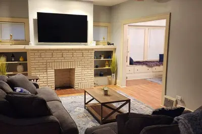 a living room with two couches and a fireplace at Comfy 3brd in Cleveland in Cleveland Heights