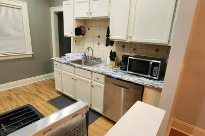 a kitchen with a sink and a microwave at Comfy 3brd in Cleveland in Cleveland Heights