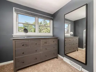 a bedroom with a dresser and a mirror at Pet-Friendly German Village Haus Wifi Walkable in Columbus