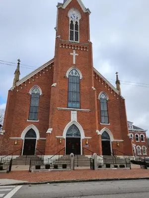 a large red brick church with a clock tower at Pet-Friendly German Village Haus Wifi Walkable in Columbus
