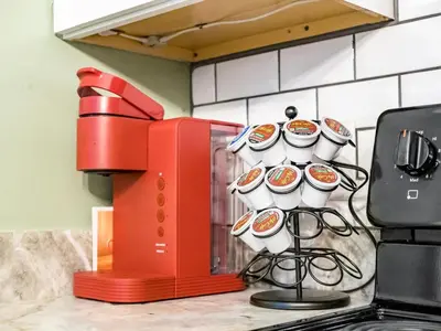 a red microwave sitting on a kitchen counter with cups at Blenkner Bungalowgvillagepetsok in Columbus