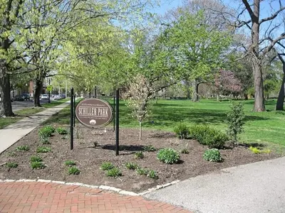 a sign in the middle of a park at Blenkner Bungalowgvillagepetsok in Columbus