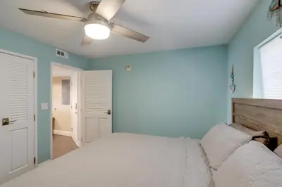 a bedroom with a bed and a ceiling fan at Waterfront Middle Bass Condo with Lake Erie Views! in Middle Bass