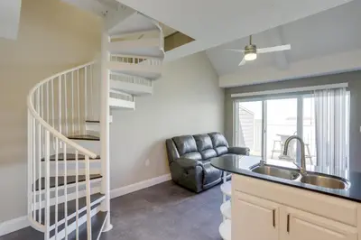 a kitchen with a spiral staircase and a sink at Waterfront Middle Bass Condo with Lake Erie Views! in Middle Bass