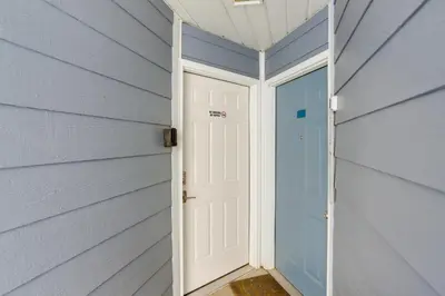 a door in a house with a blue wall at Waterfront Middle Bass Condo with Lake Erie Views! in Middle Bass