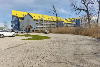 an empty parking lot in front of a large building at Waterfront Middle Bass Condo with Lake Erie Views! in Middle Bass