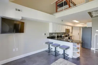 a large kitchen with a counter and stools at Waterfront Middle Bass Condo with Lake Erie Views! in Middle Bass