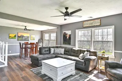 a living room with a couch and a table at Quiet Kentucky Vacation Rental with Hot Tub in Berry