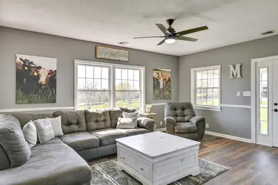 a living room with a couch and chairs and a ceiling fan at Quiet Kentucky Vacation Rental with Hot Tub in Berry