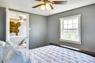 a bedroom with a bed and a ceiling fan at Quiet Kentucky Vacation Rental with Hot Tub in Berry