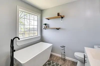 a white bathroom with a tub and a window at Quiet Kentucky Vacation Rental with Hot Tub in Berry