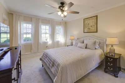 a bedroom with a bed and a ceiling fan at The Windmill House with Pond 9 Mi to Dayton! in Dwyer