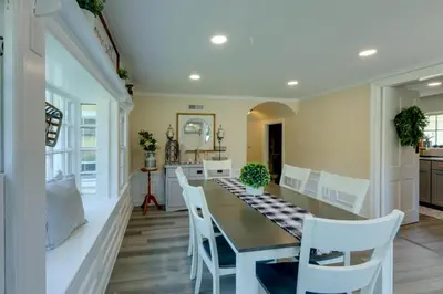 a dining room with a table and white chairs at The Windmill House with Pond 9 Mi to Dayton! in Dwyer