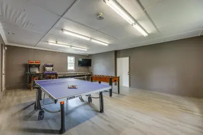 an empty room with a ping pong table in it at The Windmill House with Pond 9 Mi to Dayton! in Dwyer