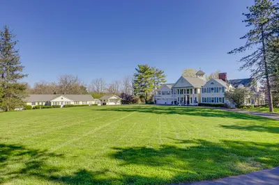 a large lawn in front of a large house at The Windmill House with Pond 9 Mi to Dayton! in Dwyer