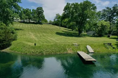 a bench sitting in the middle of a pond at The Windmill House with Pond 9 Mi to Dayton! in Dwyer