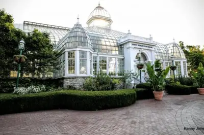 a large glass house with a garden in front of it at King BR minutes from downtown in Columbus