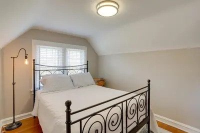 a bedroom with a bed and a window at Walk to Lake Erie Chic Home, Private Yard and Deck in Avon Lake