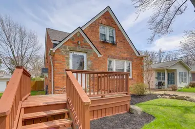 a house with a large wooden deck in front of it at Walk to Lake Erie Chic Home, Private Yard and Deck in Avon Lake