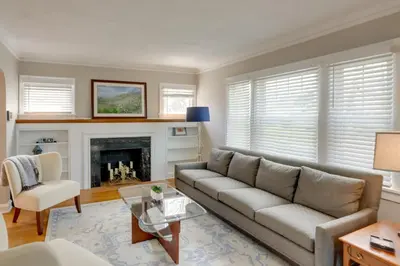 a living room with a couch and a fireplace at Walk to Lake Erie Chic Home, Private Yard and Deck in Avon Lake