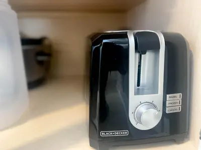 a toaster is sitting on a kitchen counter at The Cranbrook- Close to OSU-Downtown Columbus-Short North-Clintonville-Upper Arlington in Columbus