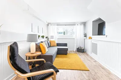 a living room with a couch and a table at The Cranbrook- Close to OSU-Downtown Columbus-Short North-Clintonville-Upper Arlington in Columbus