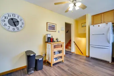 a kitchen with a clock on the wall and a refrigerator at Athens Vacation Rental - 6 Mi to Ohio University! in Athens