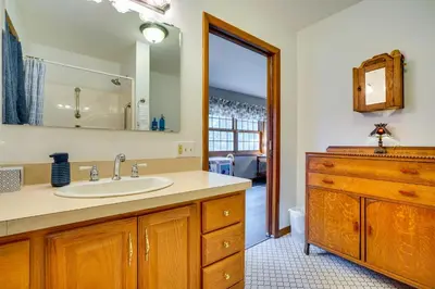 a bathroom with a sink and a large mirror at Athens Vacation Rental - 6 Mi to Ohio University! in Athens