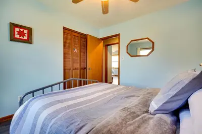 a bedroom with a bed and a mirror on the wall at Athens Vacation Rental - 6 Mi to Ohio University! in Athens