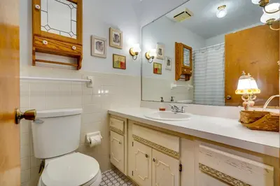 a bathroom with a toilet and a sink and a mirror at Athens Vacation Rental - 6 Mi to Ohio University! in Athens