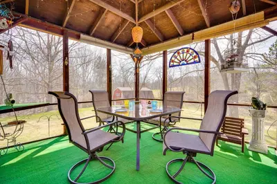 a screened in porch with a table and chairs at Athens Vacation Rental - 6 Mi to Ohio University! in Athens