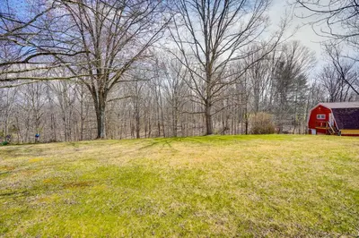 a red barn in the middle of a field at Athens Vacation Rental - 6 Mi to Ohio University! in Athens