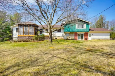 a house with a tree in a yard at Athens Vacation Rental - 6 Mi to Ohio University! in Athens