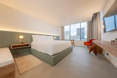 a bedroom with a bed and a desk and a television at Dayton Vitality Hotel - Downtown in Dayton