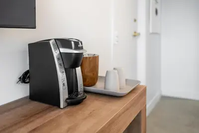 a coffee maker sitting on top of a wooden counter at Dayton Vitality Hotel - Downtown in Dayton