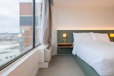 a bedroom with a bed and a large window at Dayton Vitality Hotel - Downtown in Dayton