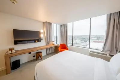 a hotel room with a bed and a large window at Dayton Vitality Hotel - Downtown in Dayton