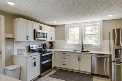 a kitchen with white cabinets and a ceiling at Williamstown Vacation Rental Private Deck and Yard in Williamstown
