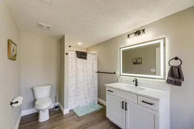 a bathroom with a sink and a toilet and a mirror at Williamstown Vacation Rental Private Deck and Yard in Williamstown